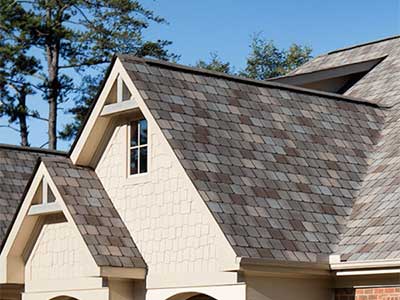 Close up of a residential roof with brown Atlas shingles of varies shades