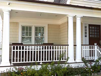 Close up of a residential front porch with beige CertainTeed siding