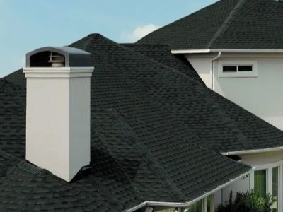 Close up of a residential roof with charcoal GAF shingles on its roof